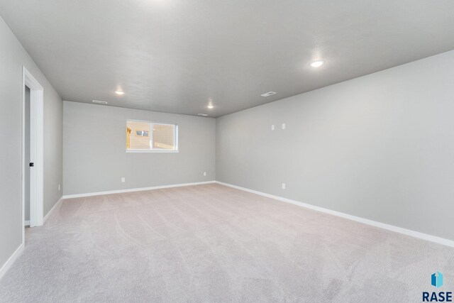 unfurnished bedroom featuring a closet, a spacious closet, and light carpet