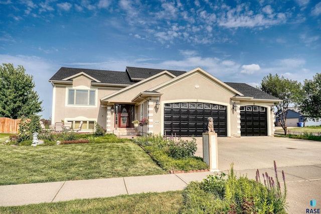 view of front of home with a garage and a front yard