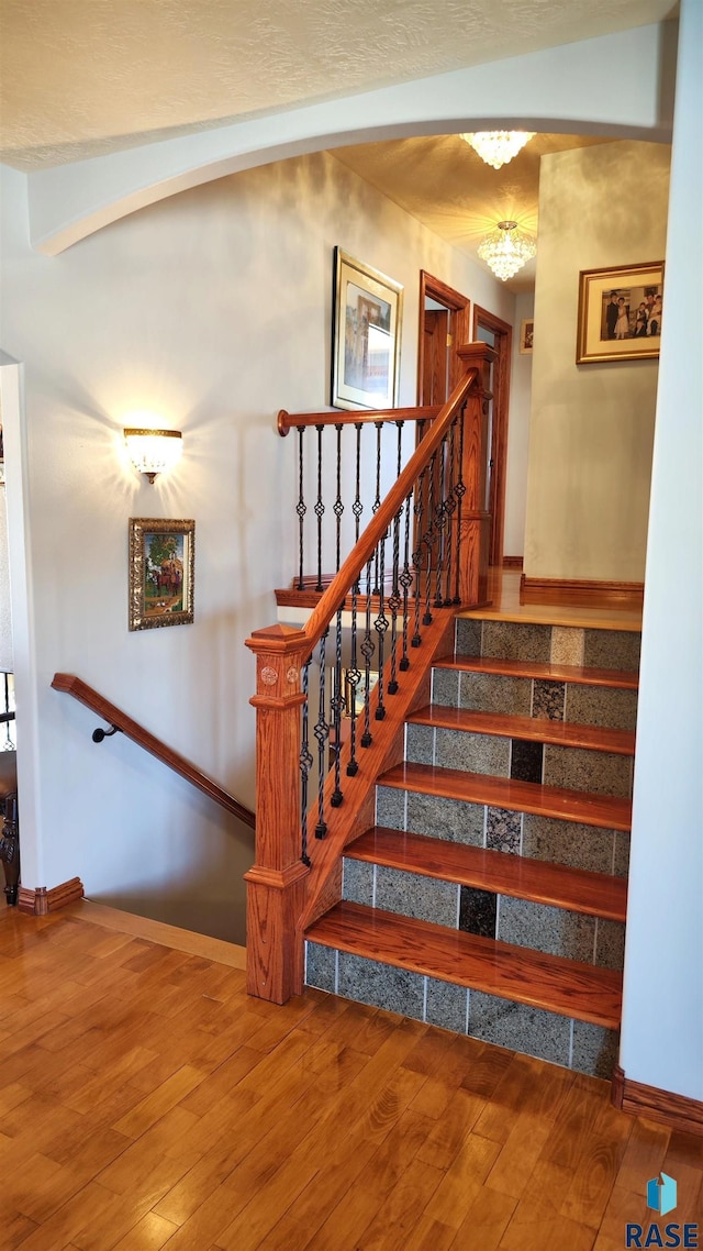 staircase with wood-type flooring