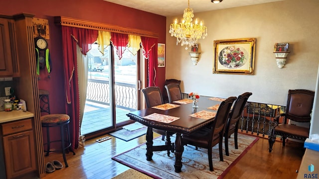 dining space featuring a wealth of natural light, an inviting chandelier, and light hardwood / wood-style flooring