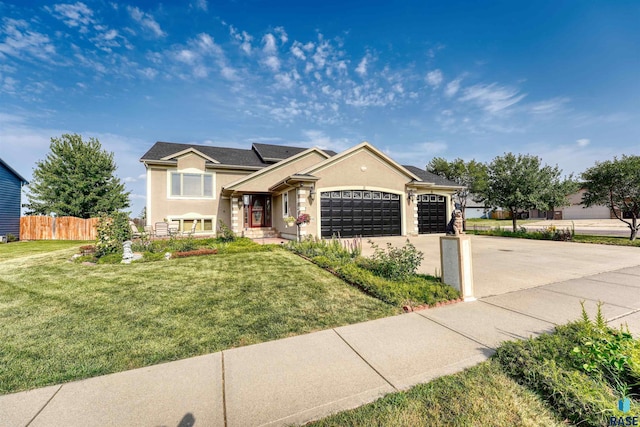 view of front of house featuring a garage and a front lawn