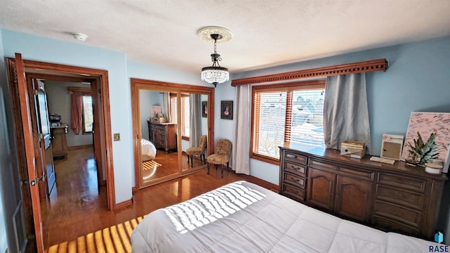 bedroom with dark hardwood / wood-style flooring