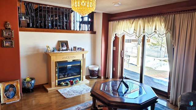 living area featuring hardwood / wood-style floors and a notable chandelier