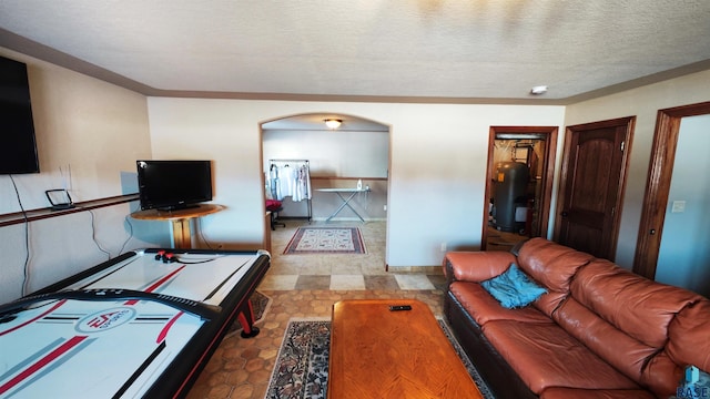 living room with water heater and a textured ceiling