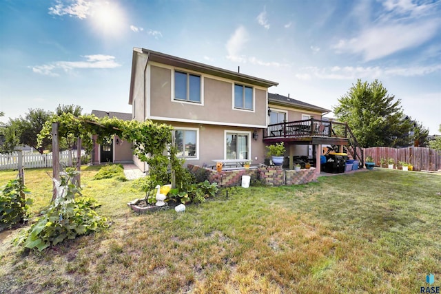 rear view of house featuring a patio area, a deck, and a lawn