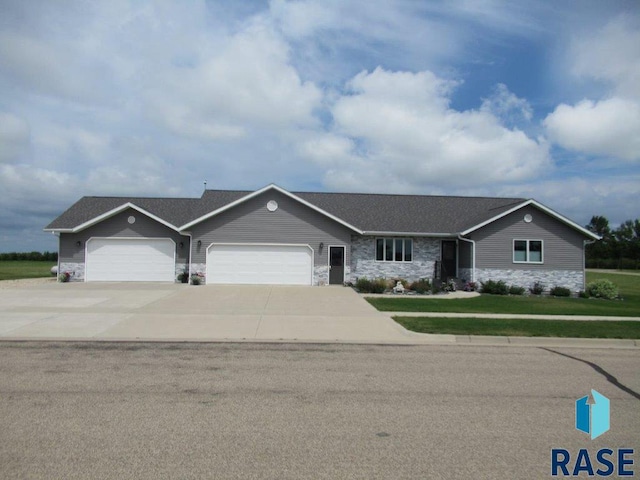 ranch-style house with a garage and a front yard