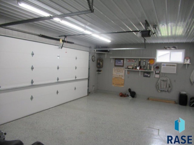 garage with an AC wall unit and a garage door opener