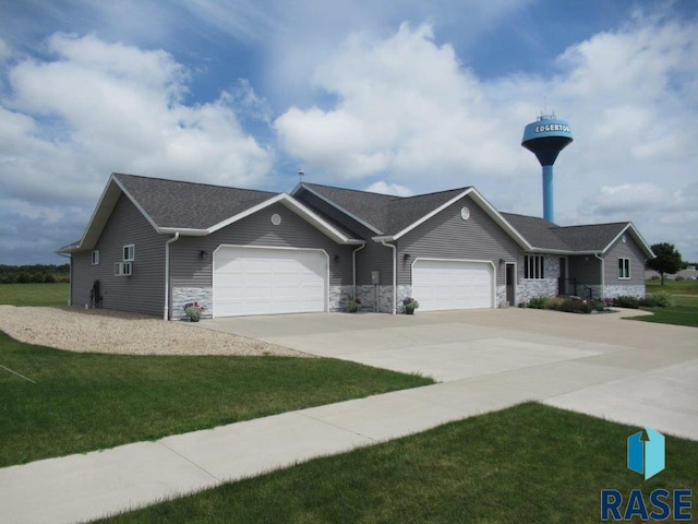 ranch-style house featuring a garage and a front lawn