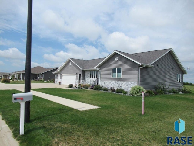 ranch-style home with a garage and a front lawn