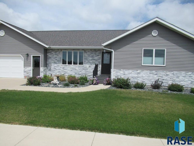 ranch-style home featuring a garage and a front yard