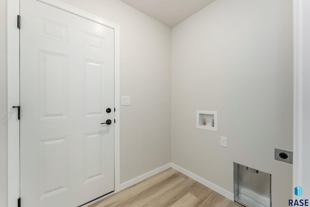 clothes washing area featuring washer hookup, hookup for an electric dryer, and light wood-type flooring