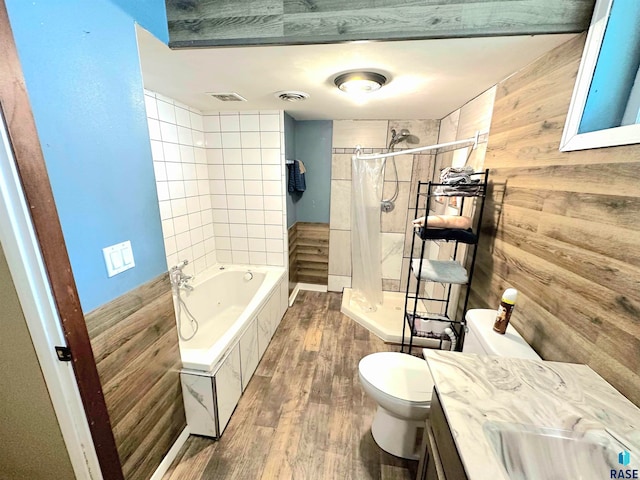 full bathroom with wooden walls, shower / bathtub combination with curtain, toilet, vanity, and hardwood / wood-style flooring