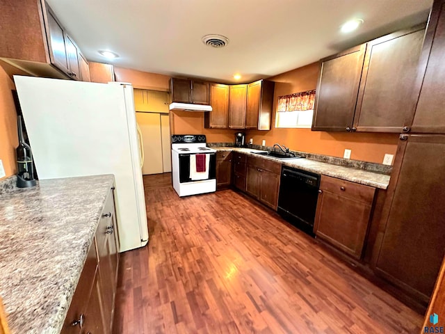 kitchen featuring sink, light hardwood / wood-style flooring, and white appliances