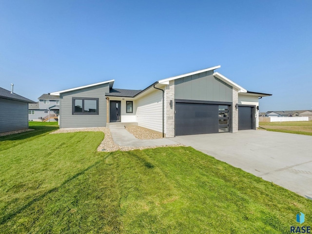 ranch-style home featuring a garage and a front yard