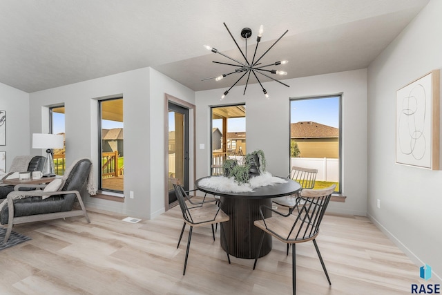 dining area featuring a chandelier and light hardwood / wood-style floors