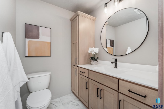 bathroom with vanity and toilet