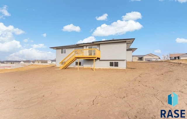 rear view of house featuring a deck