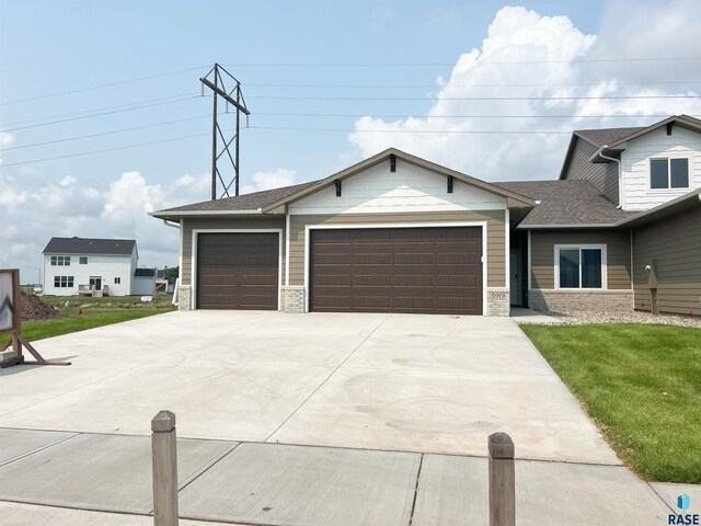 view of front of home with a garage and a front yard