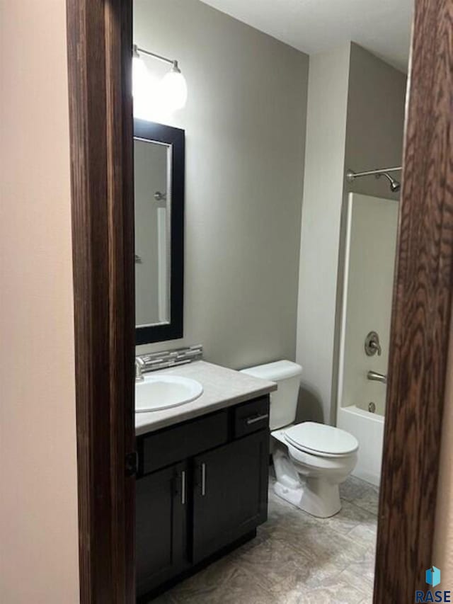 full bathroom with shower / bath combination, toilet, tile patterned floors, and vanity