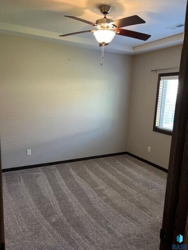 carpeted empty room featuring ceiling fan