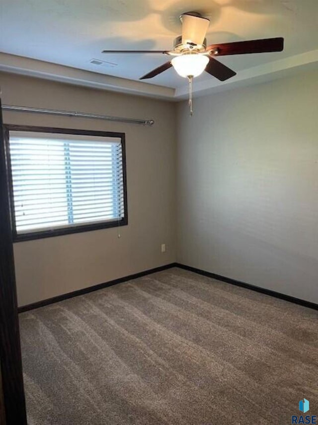 unfurnished room featuring ceiling fan and carpet floors