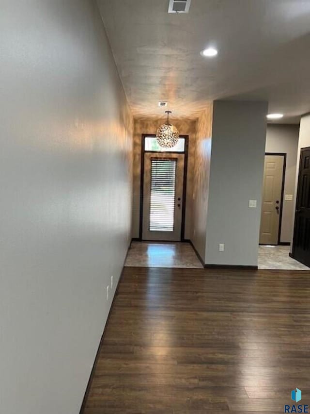 interior space featuring an inviting chandelier and wood-type flooring