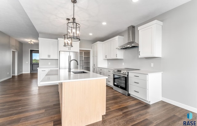 kitchen featuring dark wood-type flooring, a sink, baseboards, wall chimney range hood, and appliances with stainless steel finishes