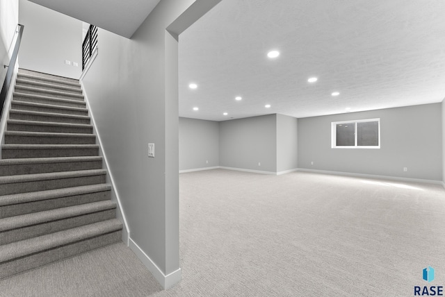 stairs with carpet, baseboards, a textured ceiling, and recessed lighting