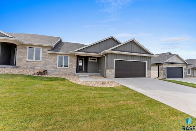 view of front of home featuring a garage, a shingled roof, concrete driveway, board and batten siding, and a front yard