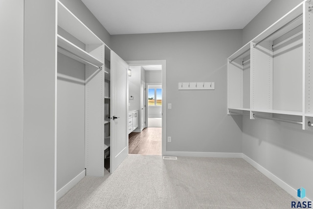 walk in closet with carpet and visible vents