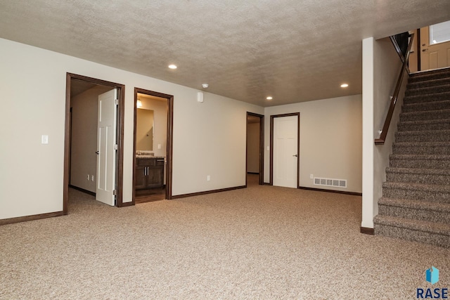 interior space with carpet floors and a textured ceiling