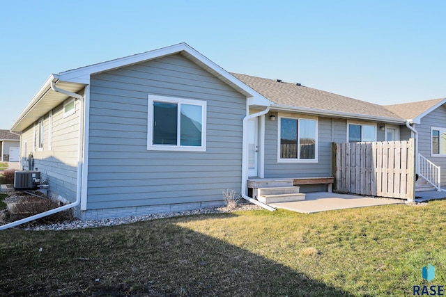 back of house featuring a yard, a patio area, and central air condition unit