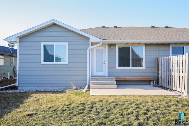 back of property featuring a yard and a patio area