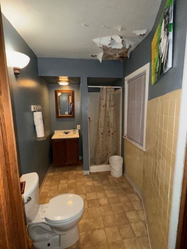 bathroom featuring tile walls, toilet, tile patterned floors, and vanity