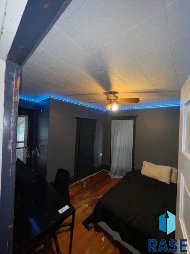 bedroom with ceiling fan and hardwood / wood-style floors