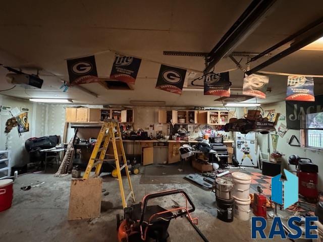 miscellaneous room with concrete flooring and a workshop area