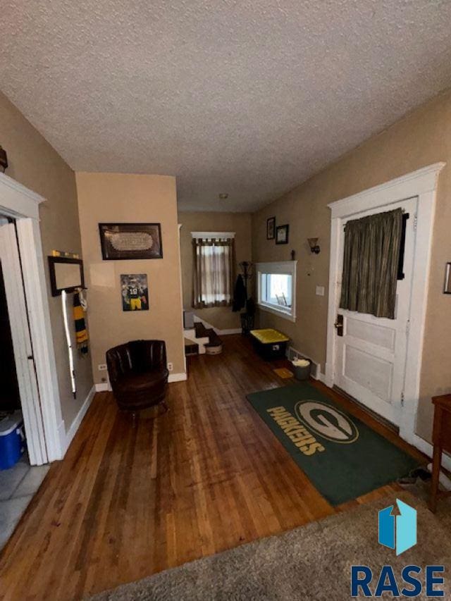 entrance foyer with a textured ceiling and hardwood / wood-style flooring