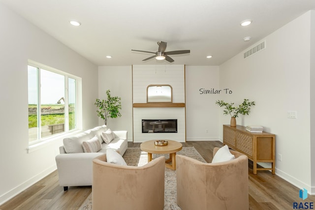 6513 S Barclay Trl, Sioux Falls, SD 57106 - living room with light wood-style flooring, a ceiling fan, baseboards, a fireplace, and recessed lighting