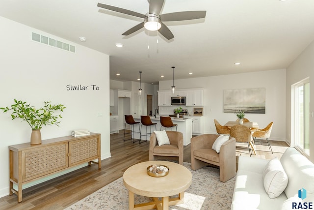 6513 S Barclay Trl, Sioux Falls, SD 57106 - living area with light wood-type flooring, recessed lighting, a ceiling fan, and baseboards