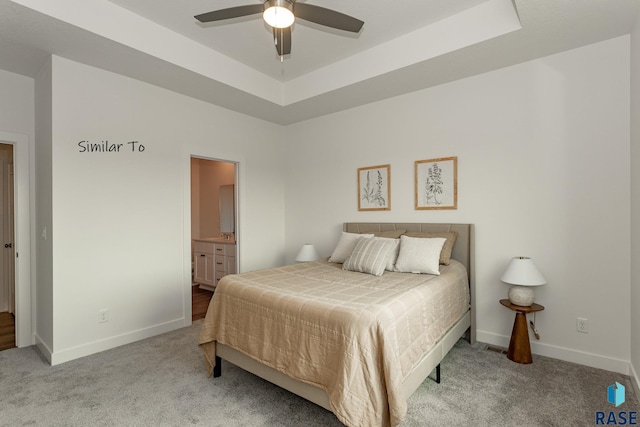 6513 S Barclay Trl, Sioux Falls, SD 57106 - bedroom featuring carpet flooring, baseboards, a raised ceiling, and ensuite bath