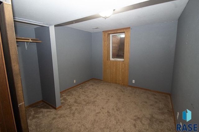 unfurnished bedroom featuring a closet, carpet flooring, and baseboards