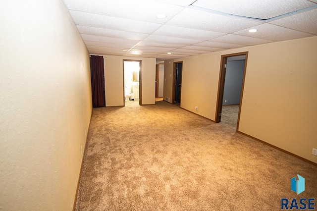 carpeted spare room with a paneled ceiling, baseboards, and recessed lighting