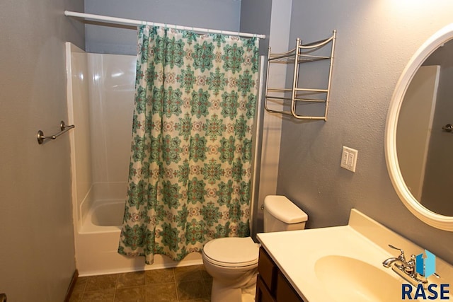 bathroom with vanity, tile patterned flooring, shower / bath combo with shower curtain, and toilet