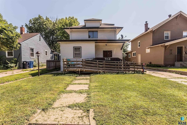 view of front of house featuring a front lawn, a wooden deck, and fence