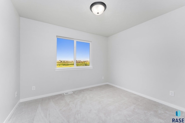 spare room with light colored carpet