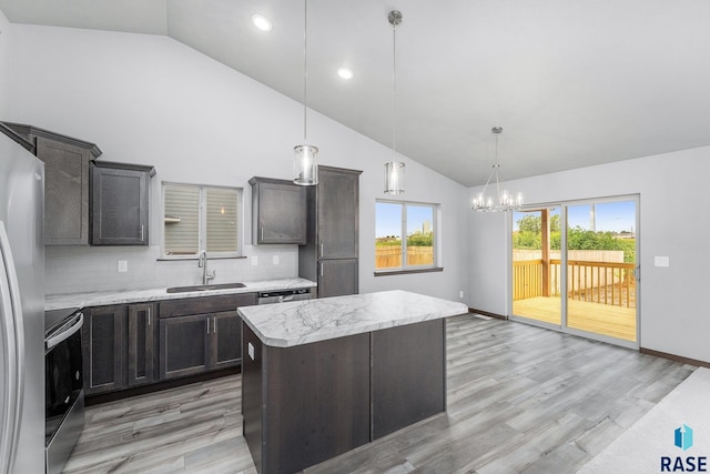 kitchen featuring sink, tasteful backsplash, light hardwood / wood-style floors, and appliances with stainless steel finishes