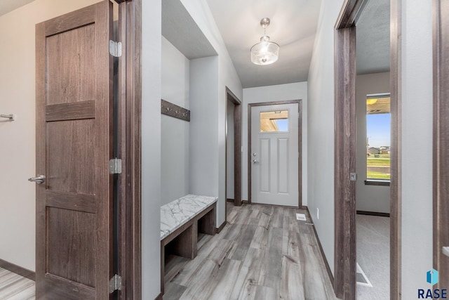 mudroom with light hardwood / wood-style floors