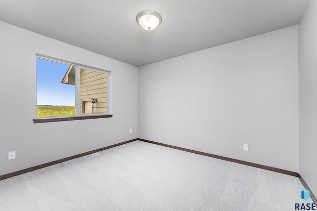 unfurnished room with carpet flooring