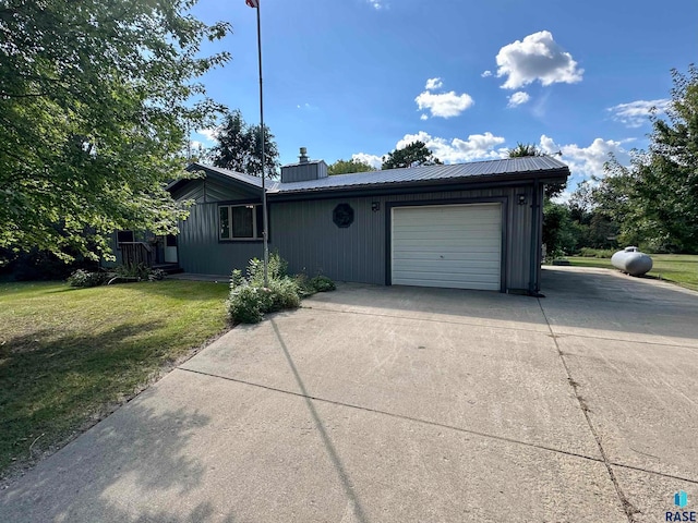 view of front of property with a garage and a front lawn