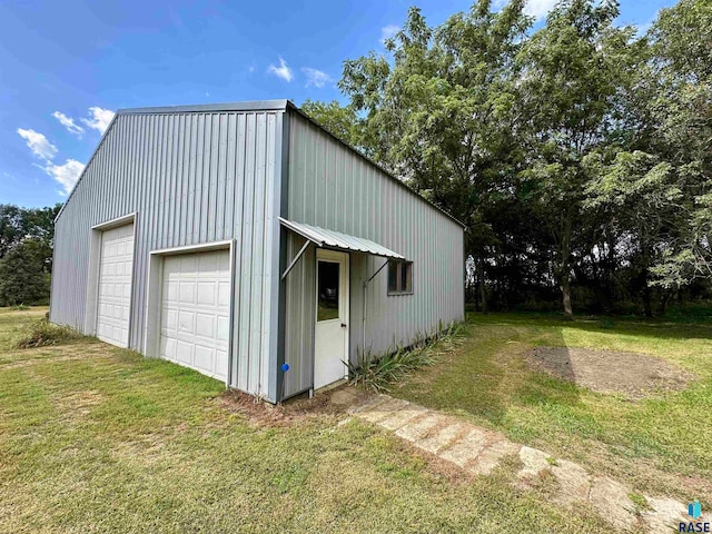 garage featuring a lawn